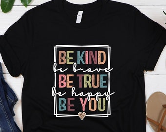 May include: Black t-shirt with a white graphic that says "BE KIND be brave BE TRUE be happy BE YOU" with a small gold heart below the text.