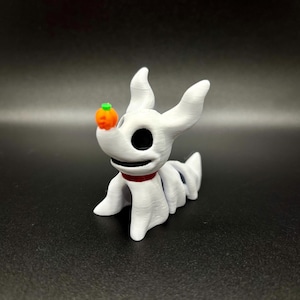May include: White 3D printed figurine of a dog with a skeleton design, holding a small orange pumpkin in its mouth. The dog has a red collar and black eyes.