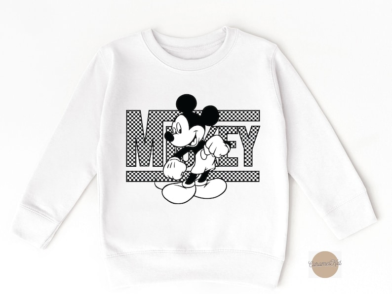May include: White sweatshirt with a black and white graphic of Mickey Mouse and the word "Mickey" printed on it.