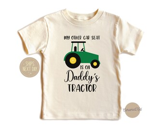 May include: A white toddler t-shirt with a green tractor graphic and the text "My other car seat is on Daddy's Tractor".