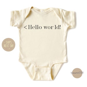 May include: A cream colored baby onesie with short sleeves and the text "<Hello world!" printed in black.