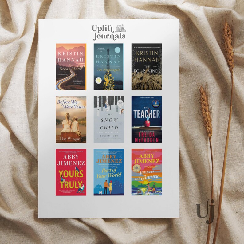May include: A white sheet of paper with a grid of nine book covers. The book covers feature a variety of colors and designs, including a blue and white cover with a lighthouse, a green and white cover with a snow child, and a red and white cover with a teacher. The text on the covers includes the titles of the books, the authors' names, and the Uplift Journals logo.
