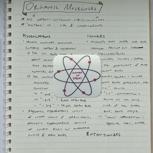May include: A handwritten page of notes on organic molecules, with a sticker of an atom with the words "Women in STEM!" in the center. The notes discuss hydrocarbons, isomers, and enantiomers.