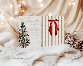 May include: A Christmas-themed invitation with a decorated tree and red bows, alongside a gift box with a red ribbon. The invitation reads "'Tis the season to be married" and includes event details. The background features soft lighting and festive decorations.