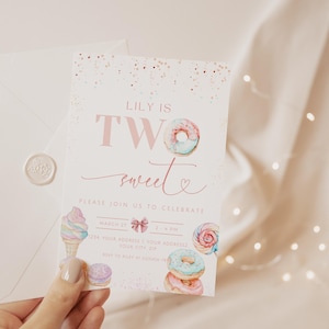 May include: A pink and white invitation card with a donut and ice cream design. The text on the card reads "Lily is Two sweet" and "Please join us to celebrate".