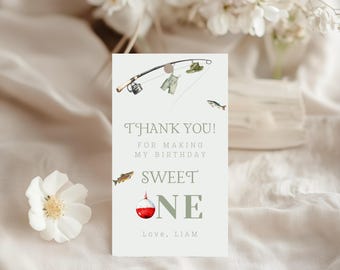 May include: A light green card with a fishing theme. The card reads "Thank You! For Making My Birthday Sweet One, Love, Liam." The card features illustrations of a fishing rod, fish, and a bobber.