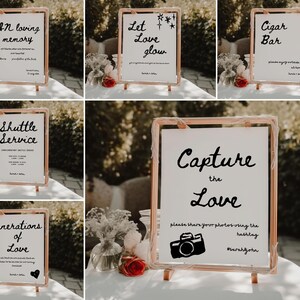 May include: A set of ten gold-framed signs with black calligraphy text. The signs include phrases like "In loving memory", "Let love glow", "Cigar Bar", "Shuttle Service", "Generations of Love", and "Capture the Love".