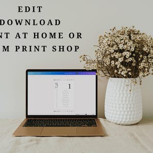 May include: A laptop computer with a white screen displaying a document with the text "Table 1" and a number "1". The laptop is on a beige surface with a vase of dried flowers in the background. The text "EDIT DOWNLOAD PRINT AT HOME OR FROM PRINT SHOP" is displayed above the laptop.