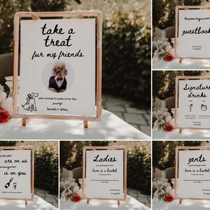 May include: A set of eight wedding signs with black calligraphy on white backgrounds. The signs are on wooden easels and include a welcome sign, a guest book sign, a signature drinks sign, a treat for my friends sign, and two signs that say "Ladies, here is a basket" and "Gents, here is a basket".