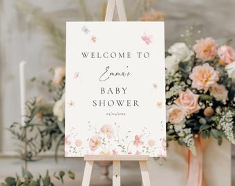 Può includere: Un cartello di benvenuto bianco con accenti floreali rosa e gialli. Il cartello recita "Benvenuti al Baby Shower di Emma 03/04/2025".