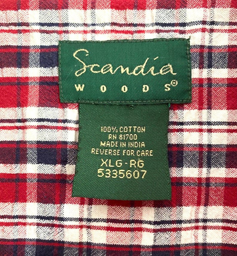 May include: A green label with white text that reads "Scandia Woods" and "100% Cotton RN 81700 Made in India Reverse for Care XLG-RG 5335607".