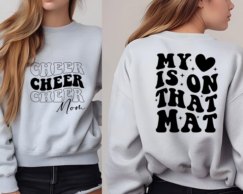 May include: Gray sweatshirt with black text that says "Cheer Cheer Cheer Mom" on the front and "My &hearts; is on that Mat" on the back.