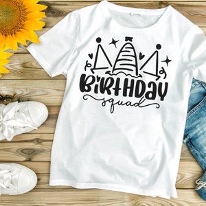 May include: White t-shirt with a black graphic design of a crown with the text "Birthday Squad".