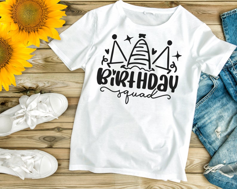 May include: White t-shirt with a black graphic design of a crown with the text "Birthday Squad".
