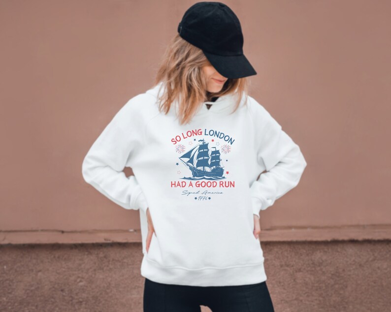 May include: White hoodie with a blue and red graphic of a ship with the text "So Long London Had a Good Run Signal America 1776".