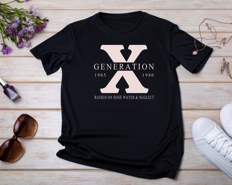 May include: Black t-shirt with a pink "X" graphic and the text "GENERATION 1965 1980 RAISED ON HOSE WATER & NEGLECT"