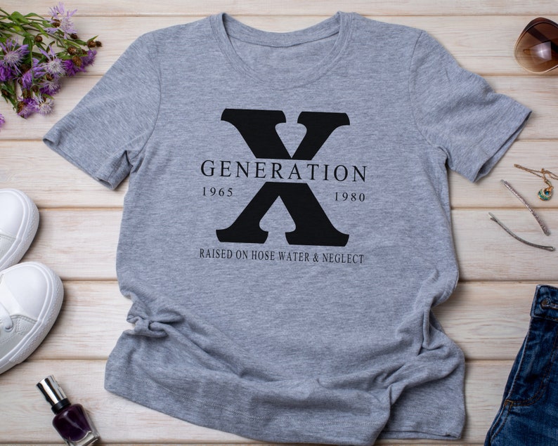 May include: Gray t-shirt with a black graphic of the letter X and the text "GENERATION 1965 1980 RAISED ON HOSE WATER & NEGLECT"
