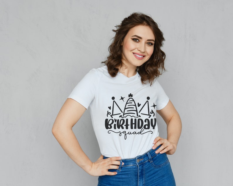 May include: White t-shirt with a black graphic of a crown with the text "Birthday Squad" underneath.