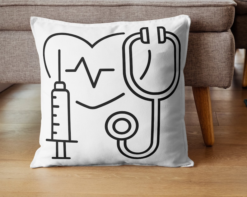 May include: White throw pillow with black line drawings of a heart with a heartbeat line, a stethoscope, and a syringe.