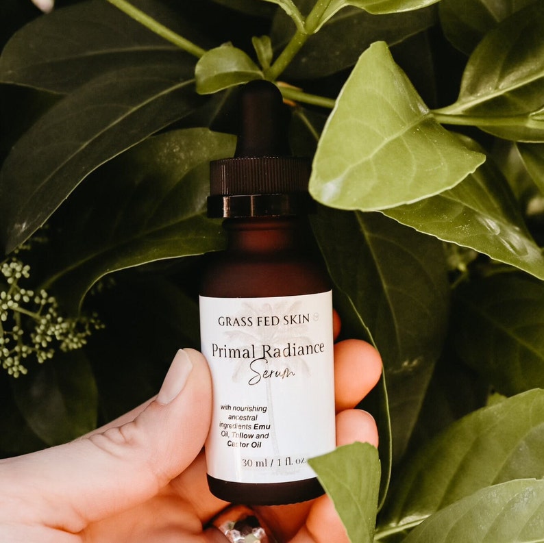 May include: A brown glass bottle with a dropper top, labeled "GRASS FED SKIN Primal Radiance Serum". The bottle contains a serum with nourishing ancestral ingredients, including Emu Oil,  Tallow and Castor Oil. The bottle is 30 ml / 1 fl. oz.
