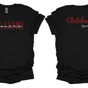 K&ouml;nnte beinhalten: Schwarzes T-Shirt mit den W&ouml;rtern "OKLAHOMA sooners" in roter und wei&szlig;er Schrift auf der Vorderseite. Auf der R&uuml;ckseite des Shirts steht das Wort "Clutchness" in roter Schrift mit dem Namen "Gasso" darunter.