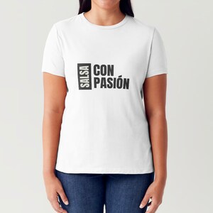 May include: White t-shirt with black text that reads "Salsa con Pasión"