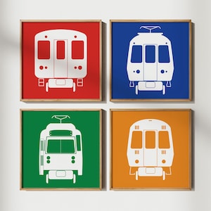 May include: Four square framed prints of white train silhouettes on colored backgrounds. The top left print has a red background, the top right print has a blue background, the bottom left print has a green background, and the bottom right print has an orange background.