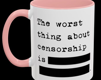 May include: White ceramic mug with a pink rim and handle. The mug has black text that reads "The worst thing about censorship is ______."