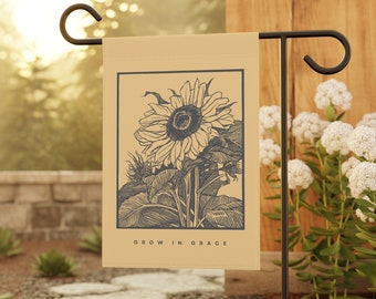 May include: A brown garden flag with a black and white illustration of a sunflower. The text "GROW IN GRACE" is printed on the flag.