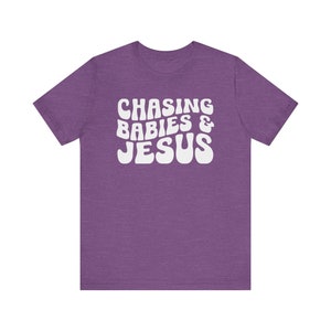 Chasing Babies and Jesus Shirt, Christian Mom Shirt, Christian Mother's Day Shirt, This Mama Prays Shirt, Christianity Shirt, Faith Based Heather Team Purple