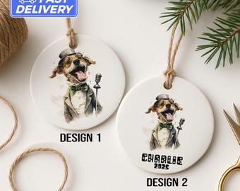 May include: Two white ceramic ornaments with watercolor illustrations of a dog in a tuxedo and top hat. One ornament has "DESIGN 1" printed below the image. The other ornament has "Charlie 2025" and "DESIGN 2" printed below the image.