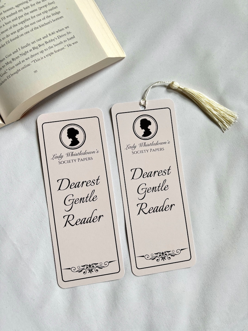 May include: Two pink bookmarks with black text and a silhouette of a woman's head. The text reads "Lady Whistledown's Society Papers" and "Dearest Gentle Reader".