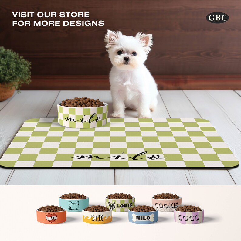 May include: A white dog sits on a green and white checkered mat with a white ceramic dog bowl filled with brown dog food. The bowl has the name "milo" written on it. The mat also has the name "milo" written on it. The image shows a variety of other dog bowls with different names and designs.
