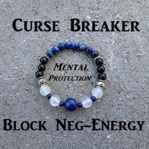 May include: A beaded bracelet with blue, black, and white stones, interspersed with silver-colored beads. The text "CURSE BREAKER", "MENTAL PROTECTION", and "BLOCK NEG-ENERGY" are displayed above and below the bracelet.
