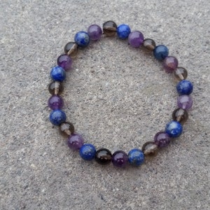 May include: A beaded bracelet with blue, purple, and brown stones.