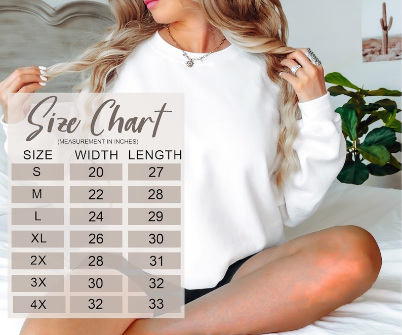 May include: Size chart for a white sweatshirt with measurements in inches. The chart shows the width and length of the sweatshirt in sizes S, M, L, XL, 2X, 3X, and 4X.