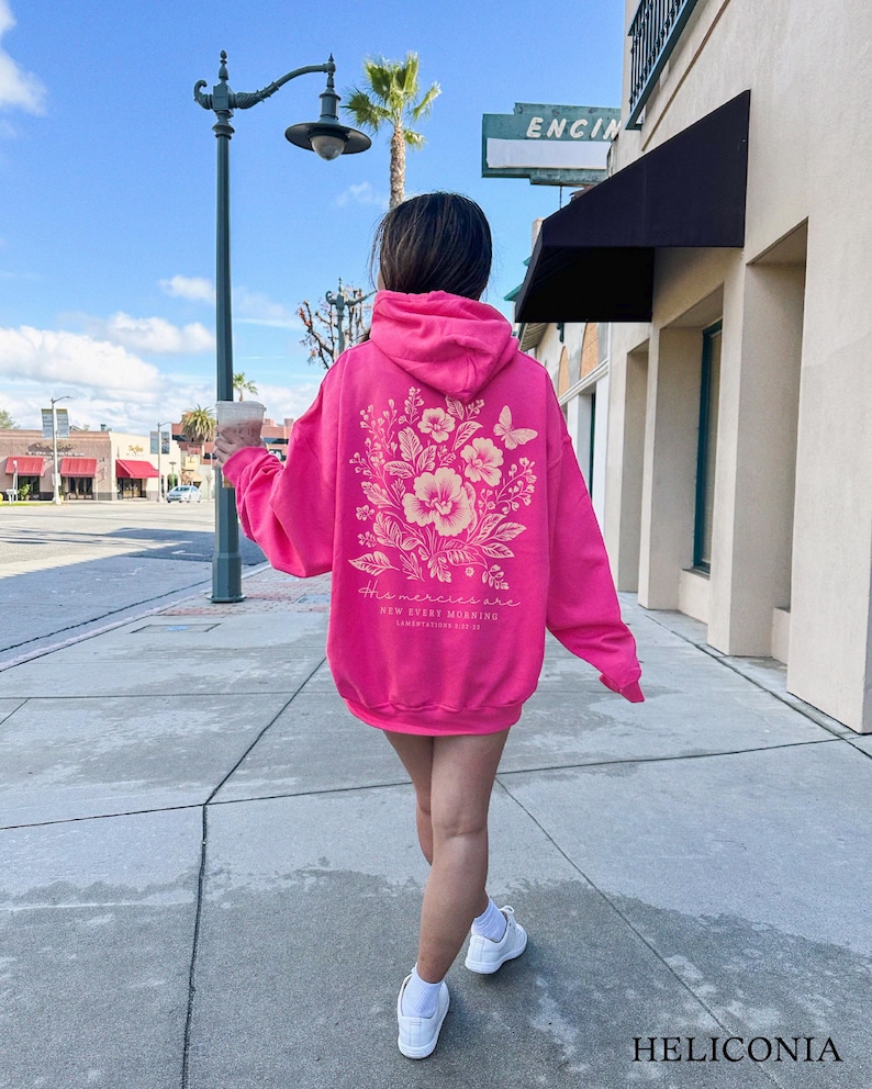 May include: A pink hoodie with a floral design and the text "The mercies are new every morning" on the back.