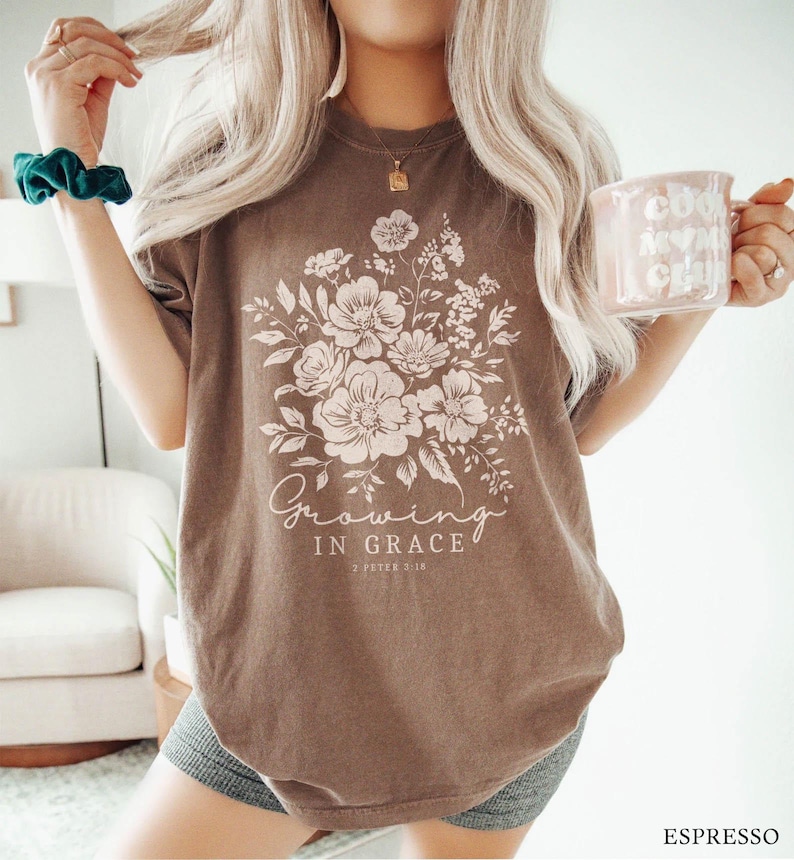 May include: A brown t-shirt with a floral design and the text "Growing in Grace 2 Peter 3:18".