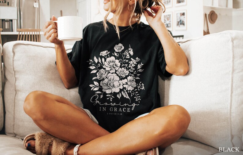 May include: A black t-shirt with a white floral design and the text "Growing in Grace 2 Peter 3:18".