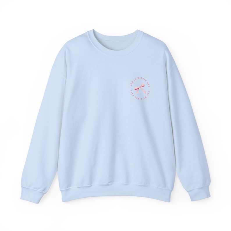 May include: Light blue sweatshirt with a pink and white graphic design that says "God is within reach, the will not fail".