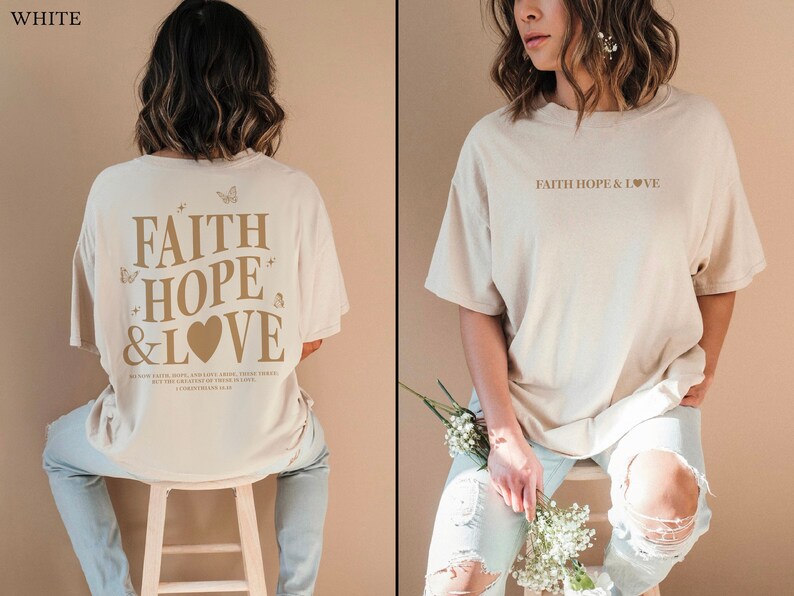 May include: A beige oversized t-shirt with the text "FAITH HOPE & LOVE" printed in brown on the front and the same text with a heart and butterflies printed in brown on the back.