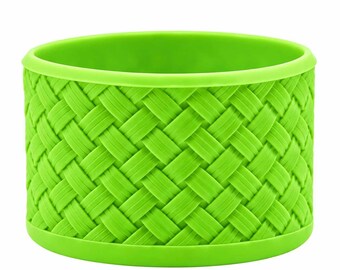 May include: A bright lime green cylindrical container featuring a textured exterior with a repeating diagonal woven pattern. The vessel has a smooth, solid rim at the top and a matching solid base, creating a uniform and consistent appearance.