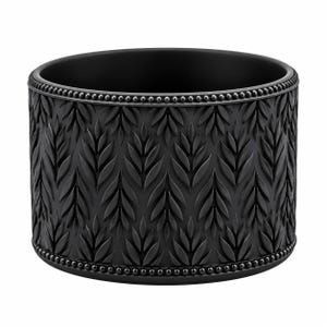 May include: A matte black cylindrical container featuring a repeating embossed leaf pattern across its exterior surface. The top and bottom edges are defined by a delicate beaded border, providing a textured contrast to the smooth leaf motifs.