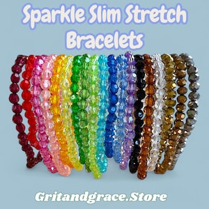May include: A collection of colorful, beaded stretch bracelets. The bracelets are arranged in a row, showcasing a spectrum of colors including red, pink, yellow, green, blue, and purple. The text "Sparkle Slim Stretch Bracelets" is displayed at the top, and "Gritandgrace.Store" at the bottom.