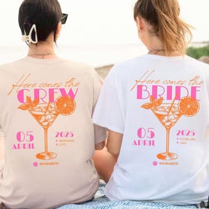 May include: Two t-shirts with a cocktail graphic. One is beige with "Here comes the CREW" and the other is white with "Here comes the BRIDE". Both have the date "05 APRIL 2025" and "BACHELORETTE" text.