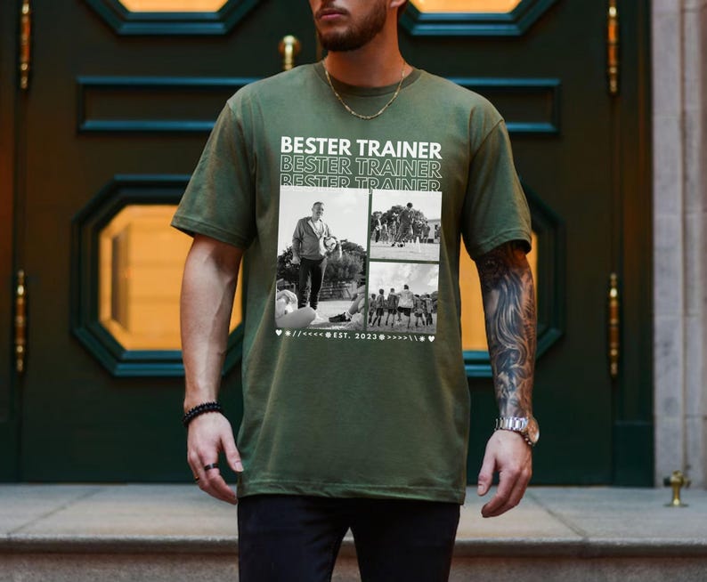 May include: An olive green t-shirt with the text "BESTER TRAINER" repeated above a collage of black and white photos. The shirt has a crew neck and short sleeves. The text "EST. 2023" is also printed on the shirt.