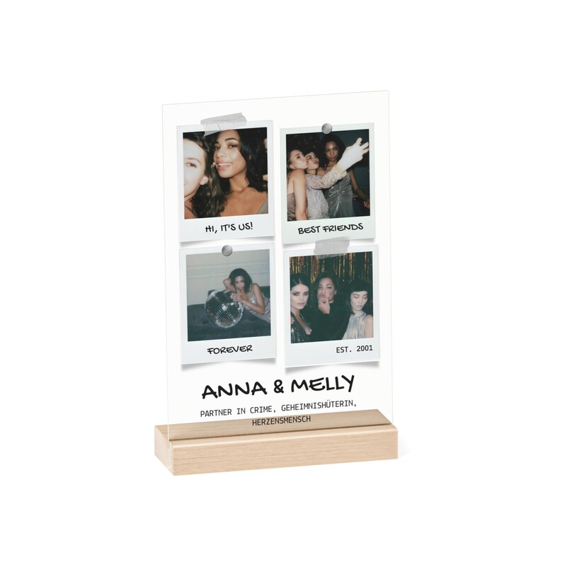 May include: A clear acrylic photo display with four square photo prints. The photos are of people. The display has a wooden base and text that reads "ANNA & MELLY" and other text below it.