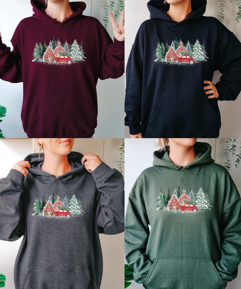 May include: A collection of four long-sleeve hooded sweatshirts in maroon, black, dark gray, and forest green. Each hoodie features a central graphic print of a red car carrying a pine tree in front of red buildings and snow-covered pine trees.