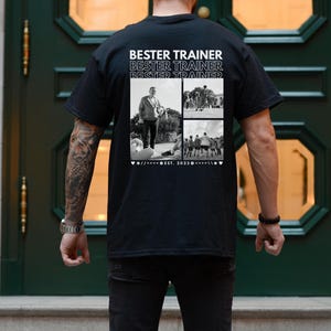 May include: Black t-shirt featuring the text "BESTER TRAINER" repeated three times. Below the text are three black and white photographs. The shirt also includes the text "EST. 2023".