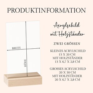 May include: A clear acrylic sign with a wooden base. The sign is labeled with the text "PRODUKTINFORMATION" and includes size details: 13 x 20 cm and 20 x 30 cm. The wooden base is rectangular.